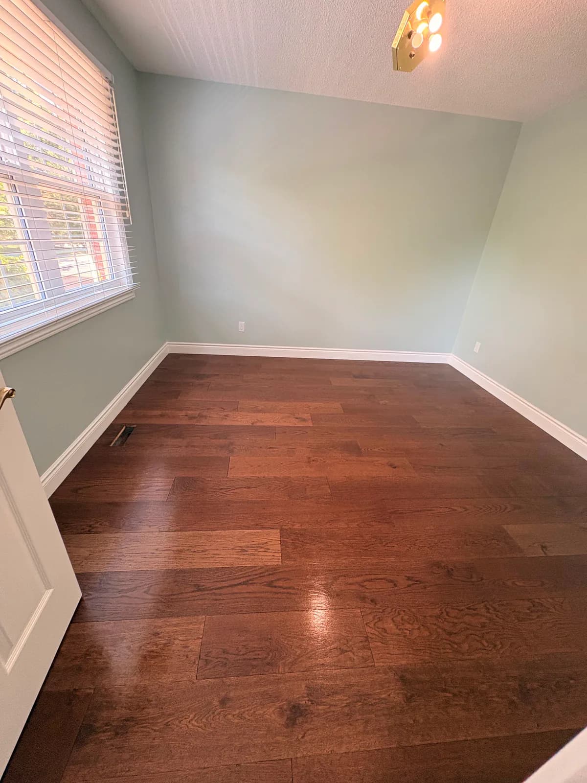After — Post-construction floor cleanup in a finished bedroom.
